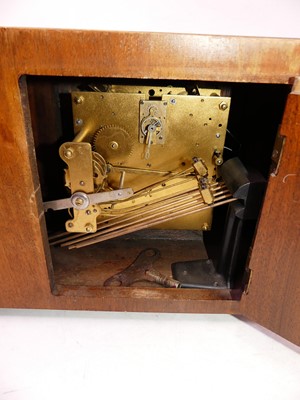 Lot 39 - A 1930s Art Deco walnut cased mantel clock,...