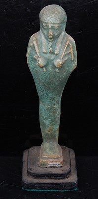 Lot 370 - An Egyptian green glazed faience shabti, the...
