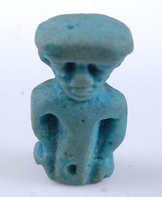 Lot 374 - An Egyptian green glazed faience amulet form...