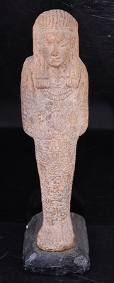 Lot 384 - An Egyptian moulded and tooled shabti figure,...