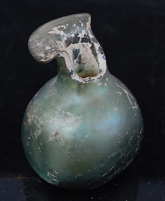 Lot 386 - An Egyptian / Roman green glass scent bottle,...