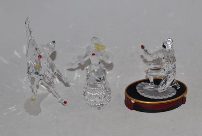 Lot 148 - A set of three Swarovski cut crystal figures,...