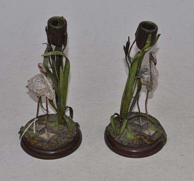 Lot 220 - A pair of painted spelter with a bronze base...
