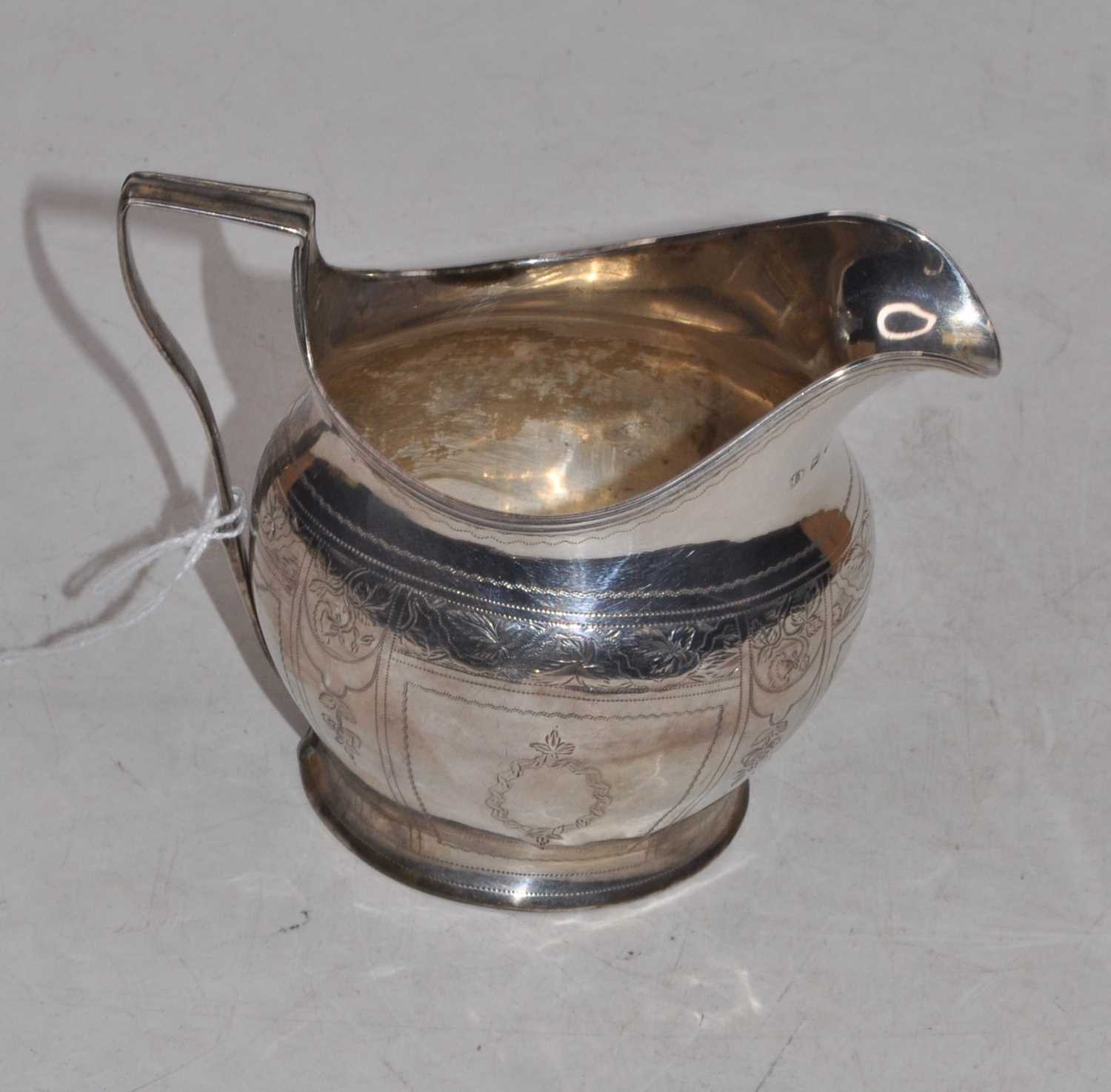 Lot 281 - A George III silver helmet shaped cream jug,...