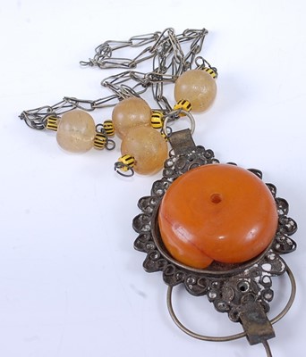 Lot 427 - A base metal and faux amber set oversize...