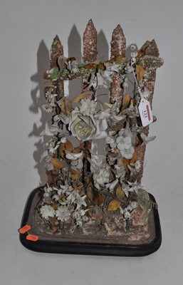 Lot 122 - A floral bone china decoupage model on...