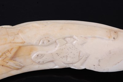 Lot 198 - A boar's tusk, carved with a crocodile and...
