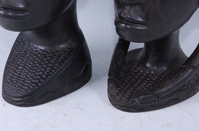 Lot 203 - A pair of East African ebony busts, carved as...