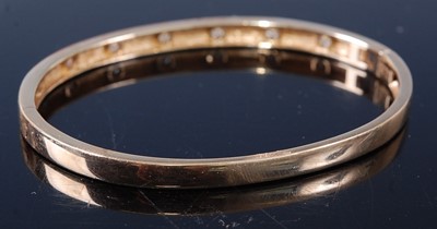 Lot 2590 - A yellow metal diamond oval hinged bangle,...