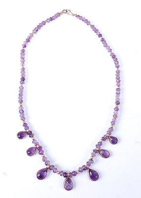 Lot 2598 - An amethyst and yellow metal rondel fringe...