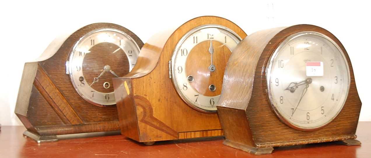 Lot 16 - A 1950s walnut cased mantel clock, having...