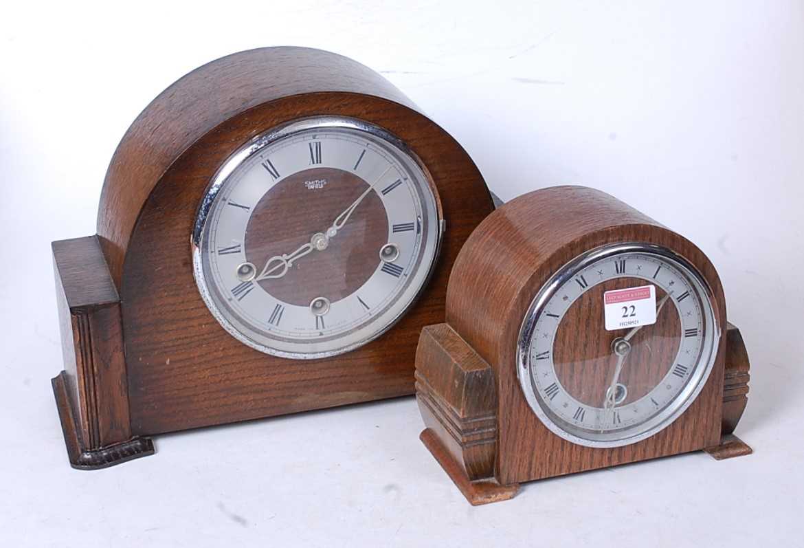 Lot 22 - A 1950s oak cased mantel clock, having a...