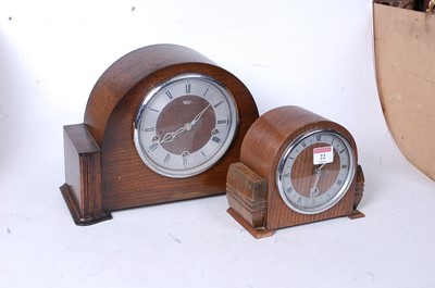 Lot 22 - A 1950s oak cased mantel clock, having a...