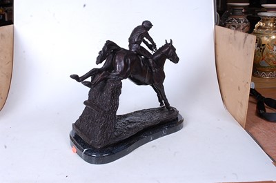 Lot 46 - A bronzed figure of a racehorse and jockey...