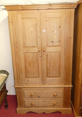 Lot 1129 - A modern pine double door wardrobe, having...