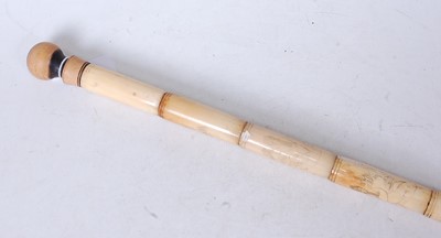 Lot 119 - A faux ivory walking stick, each section...