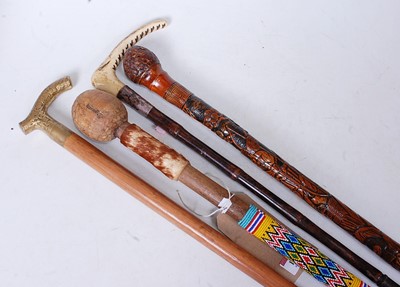 Lot 124 - An African staff, having a coloured bead and...