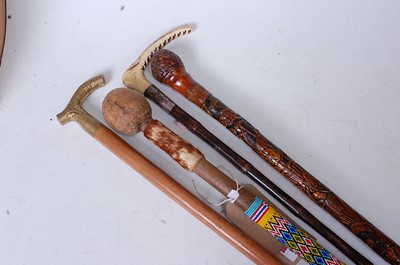 Lot 124 - An African staff, having a coloured bead and...