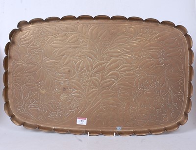 Lot 125 - An Arts & Crafts brass tray, of shaped...