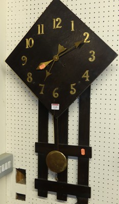 Lot 1140 - An Arts & Crafts influenced oak wall clock,...