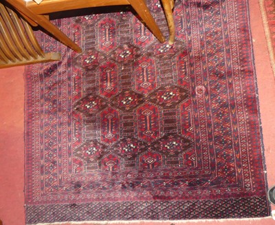 Lot 1155 - A Persian woollen red ground Bokhara rug, the...