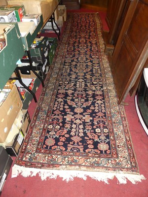 Lot 1160 - A Persian woollen blue ground Shiraz long hall...