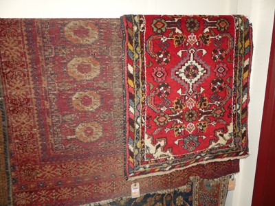 Lot 1162 - An extremely worn and faded Persian red ground...