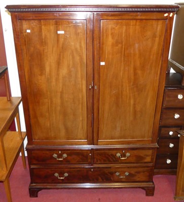 Lot 1169 - A 19th century mahogany linenpress, the twin...