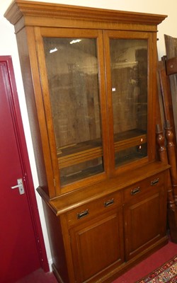 Lot 1171 - A circa 1900 oak bookcase cupboard having twin...