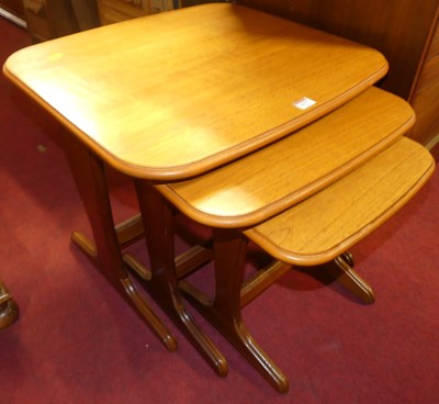 Lot 1277 - A 1980s teak nest of three occasional tables,...