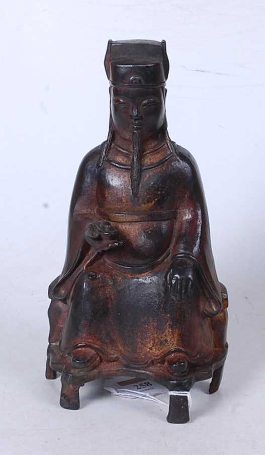 Lot 258 - A Chinese cast metal figure of a seated...
