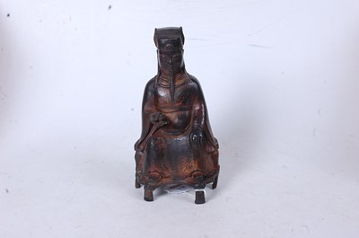 Lot 258 - A Chinese cast metal figure of a seated...