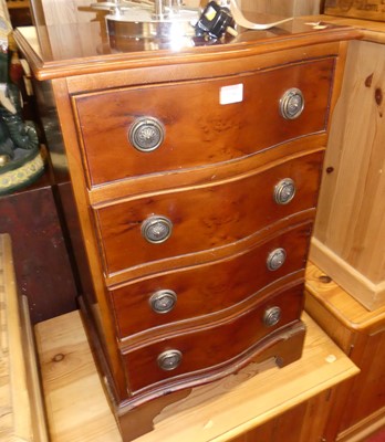 Lot 1198 - A reproduction yew wood four drawer serpentine...