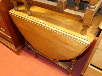 Lot 1227 - A 1930s barley twist oak drop leaf table...