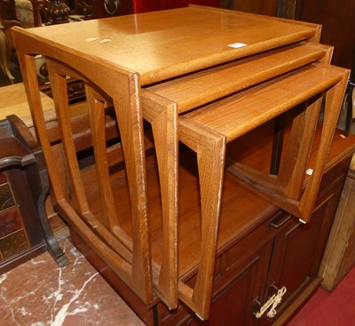 Lot 1236 - A 1970s teak nest of three occasional tables,...