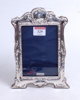 Lot 329 - A modern silver clad easel photo frame in the...