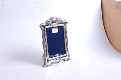 Lot 329 - A modern silver clad easel photo frame in the...