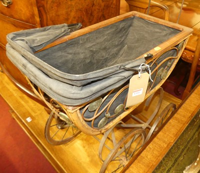 Lot 1311 - A metal, bamboo and canvas dolls pram