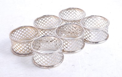 Lot 333 - A set of six modern silver napkin rings, of...