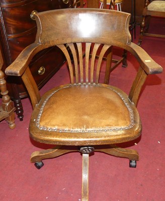 Lot 1348 - A 1930s oak tub splatback swivel desk chair,...