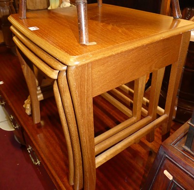 Lot 1390 - A 1980s teak nest of three occasional tables,...