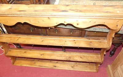 Lot 1412 - A rustic stained pine three-tier hanging plate...