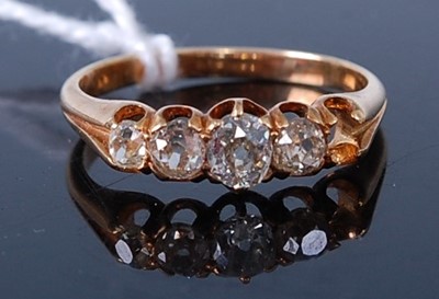Lot 392 - A yellow gold diamond five stone ring (one...