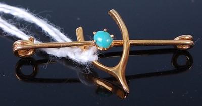 Lot 395 - A 9ct gold and turquoise set wishbone safety...