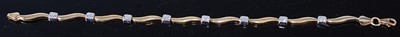 Lot 401 - A modern 9ct yellow and white gold wavy bar...