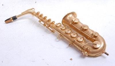 Lot 477 - A modern miniature brass saxophone, in velvet...