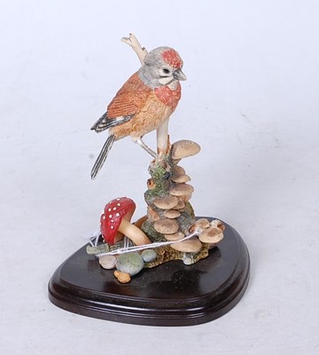 Lot 228 - A Country Artists resin model of a bird upon a...