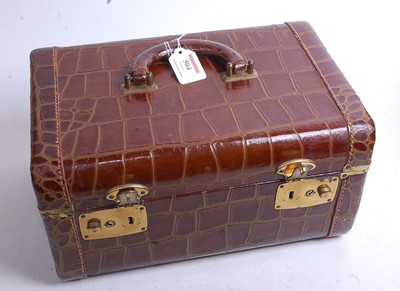 Lot 504 - An aligator skin covered travel case with...