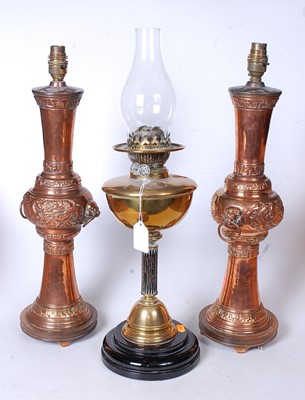 Lot 28 - A late Victorian oil lamp having a brass font...