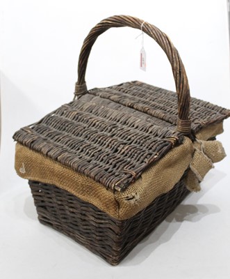 Lot 646 - A wicker basket with double hinged cover